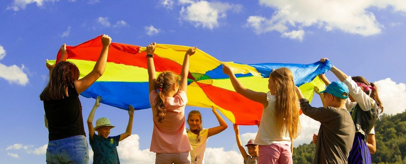 group of women standing on green grass field during daytime